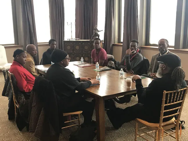 Trainees gathered around a dining table for a classroom session
