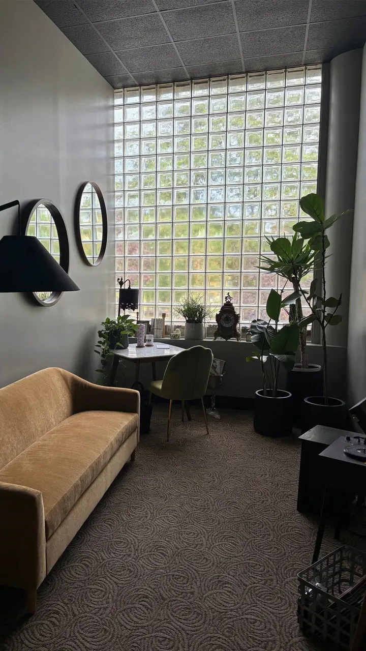 The Sound Lounge sofa beside a tall glass-block window