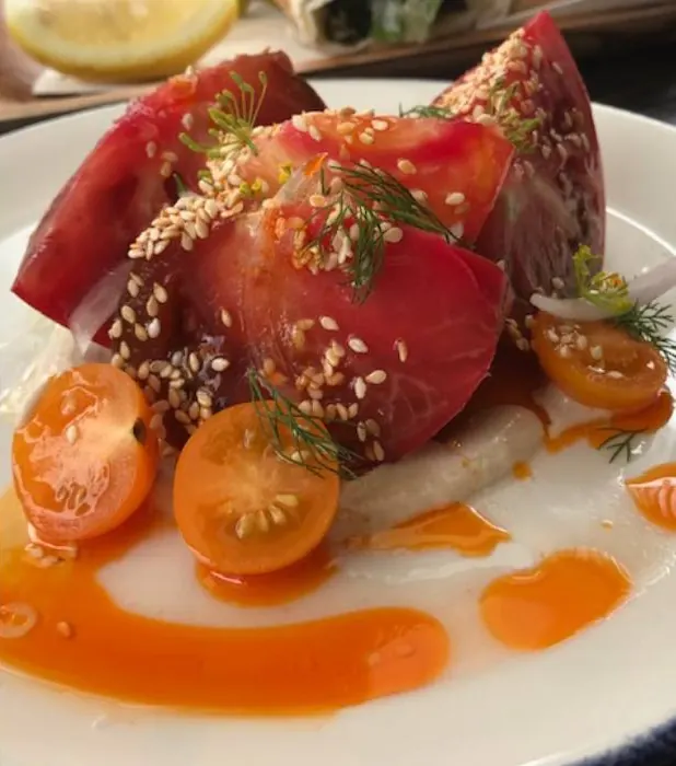 Heirloom tomato salad with sesame, dill and an orange sauce